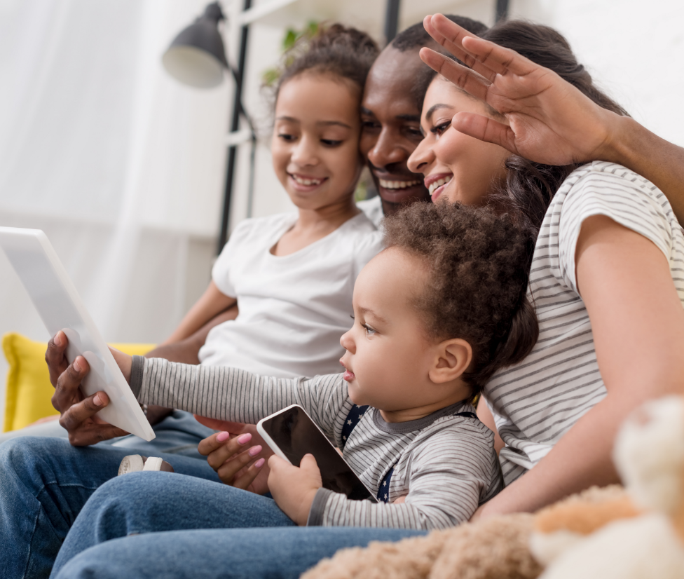 Family looking at tablet 2x